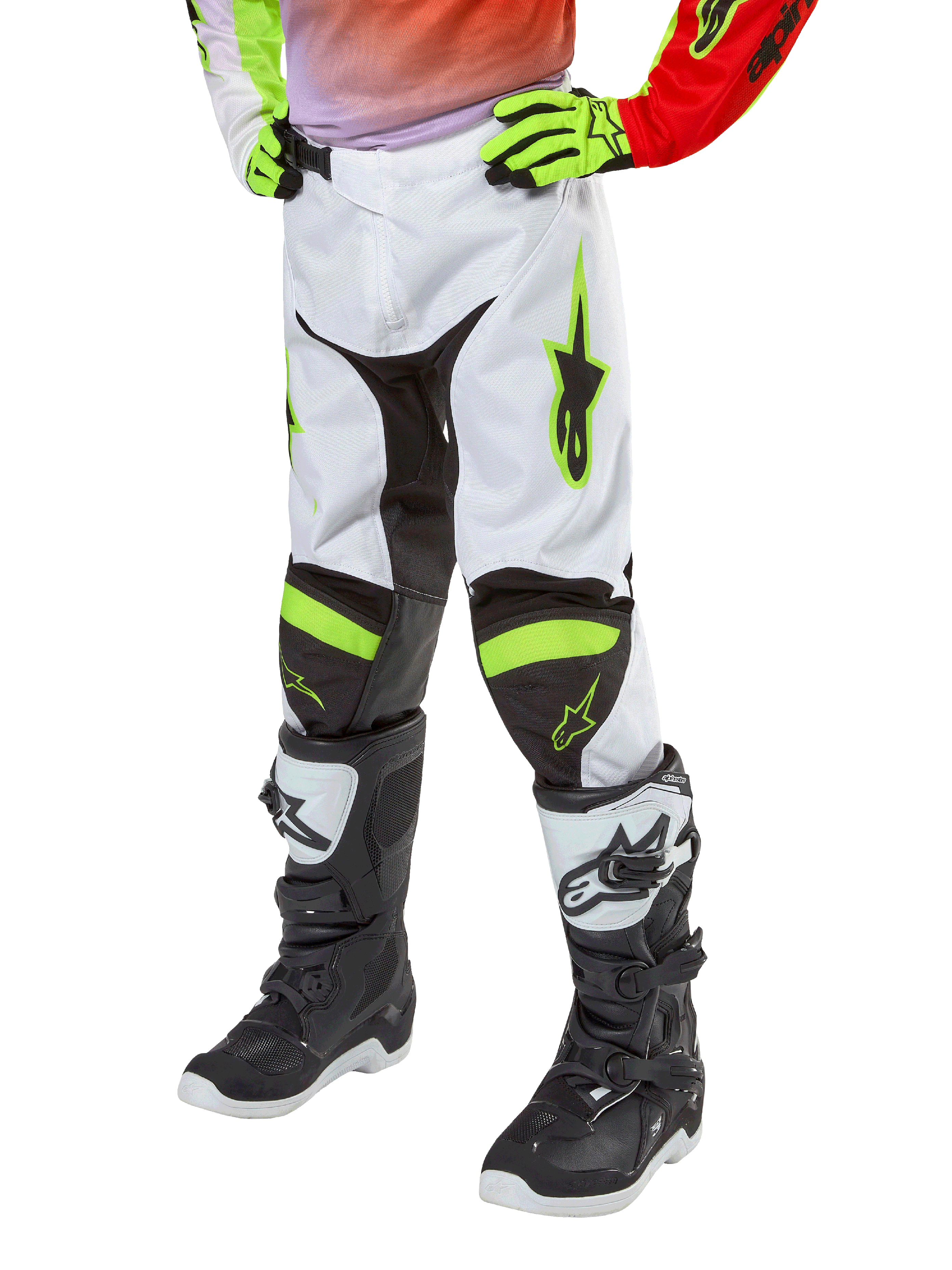 Alpinestars Youth 2024 Racer Lucent Pants, Motocross Pants, White Neon Red and Yellow Fluo, lower-body view featuring black stretch panels and neon accents, worn with black and white racing boots and neon yellow gloves, technical off-road gear for youth
